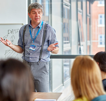 A teacher addressing students