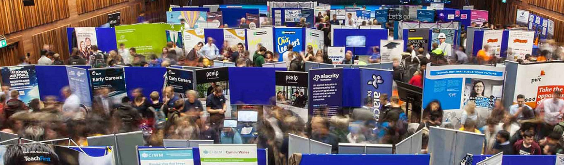 Students in a jobs fair, talking to employers