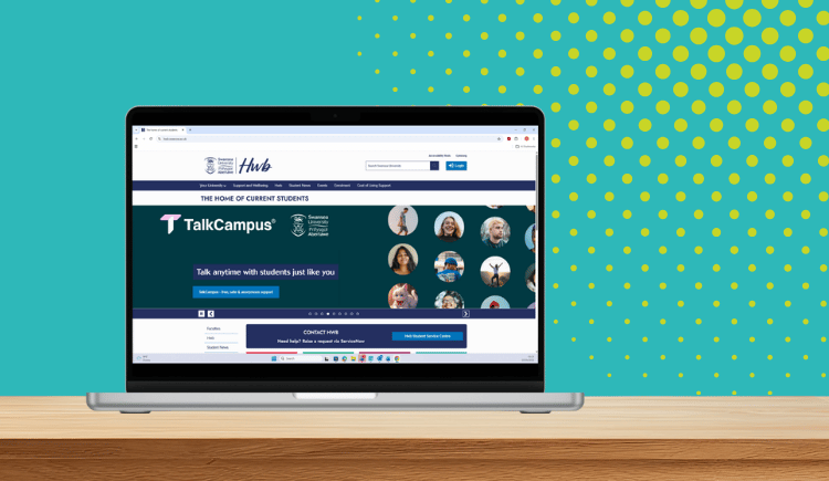 Hwb website on laptop screen. Turquoise background. 