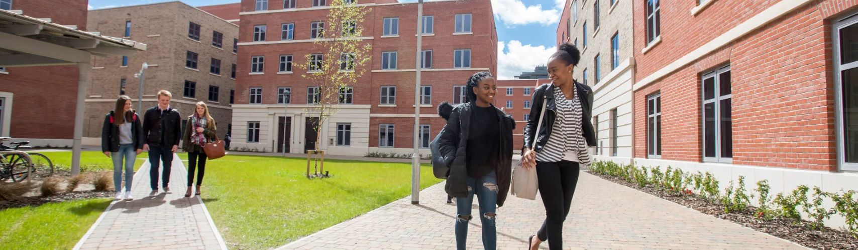 Photograph of students walking through courtyard at Bay Campus.